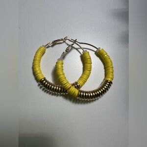 Bright yellow hoop earrings.